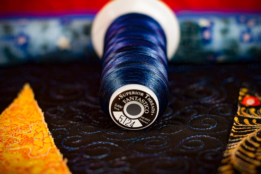 Indigo Fantastico thread for the background quilting