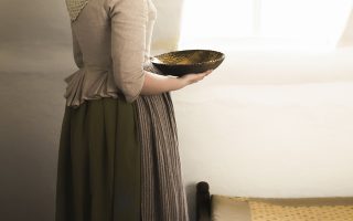 working woman getting dressed in the 18th century