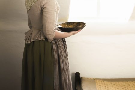 working woman getting dressed in the 18th century