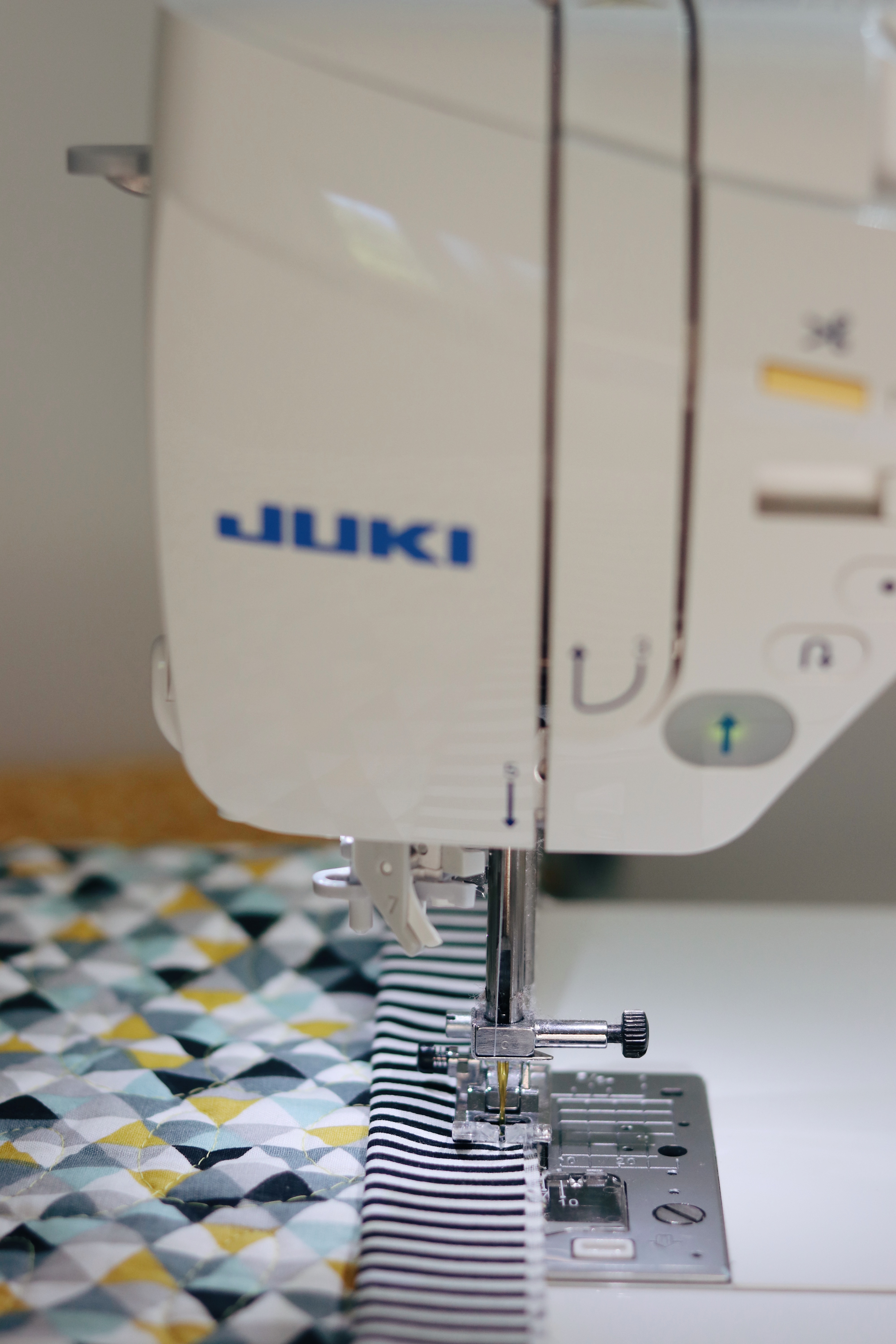 Machine stitching the binding with the Juki DX7