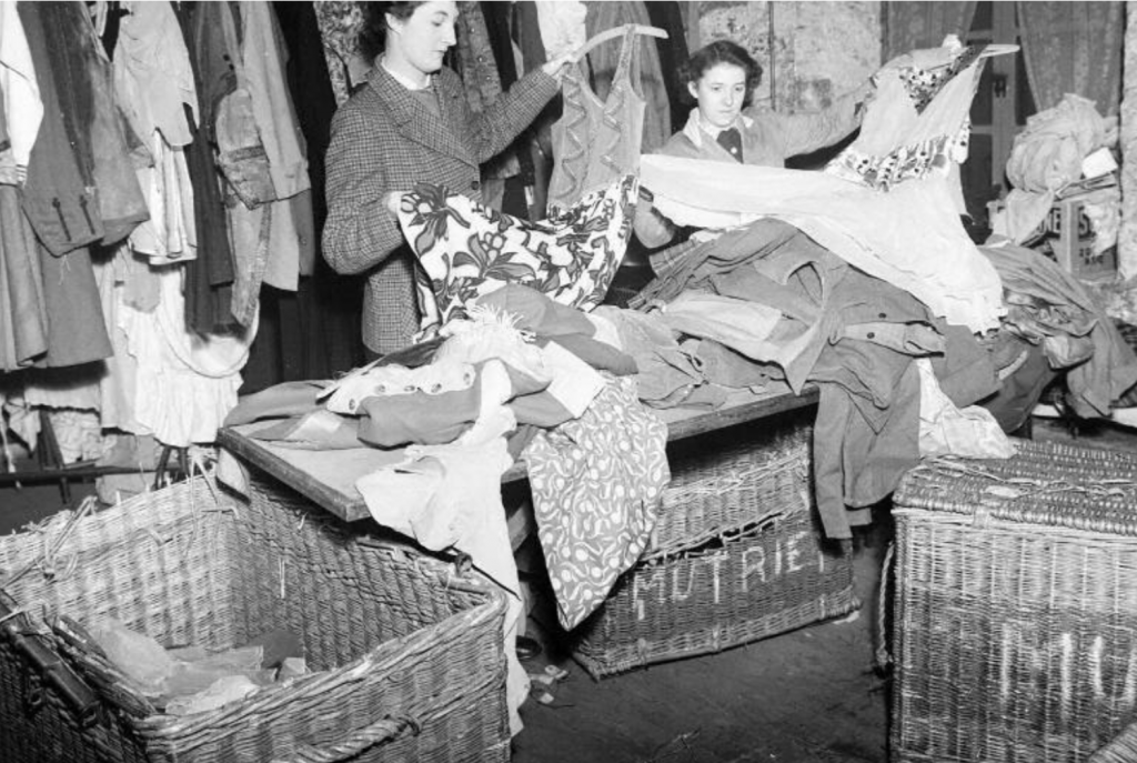 Mutrie and Sons costumiers Edinburgh historic photo - women sort through sewn textile costumes