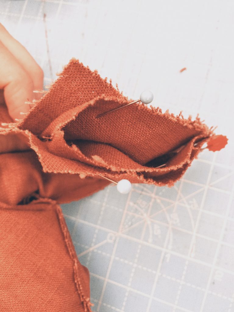 pinning the orange brown linen shoulder pieces using all in one facing method