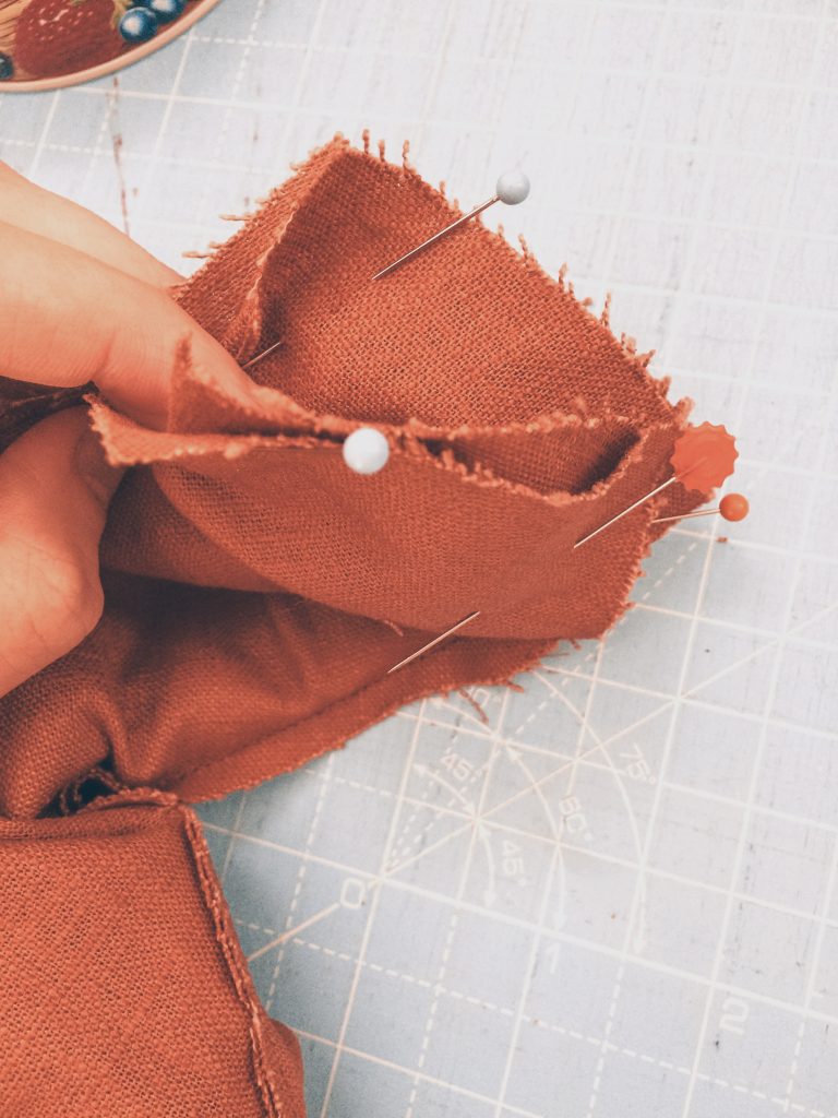 pinning the orange brown linen shoulder pieces using all in one facing method