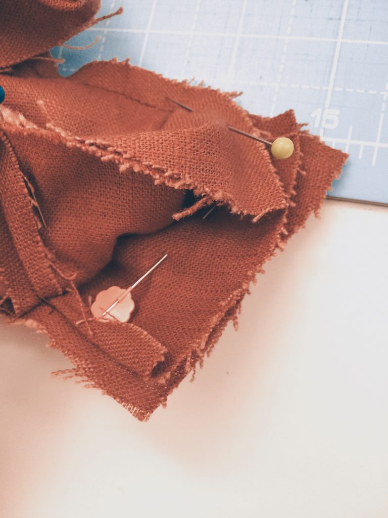 pinning the orange brown linen shoulder pieces using all in one facing method