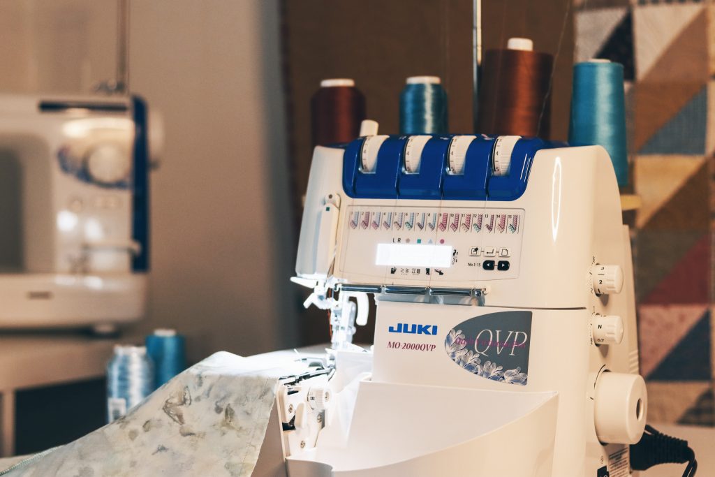 Juki MO-2000QVP Overlocker sewing machine with blue and brown fabrics