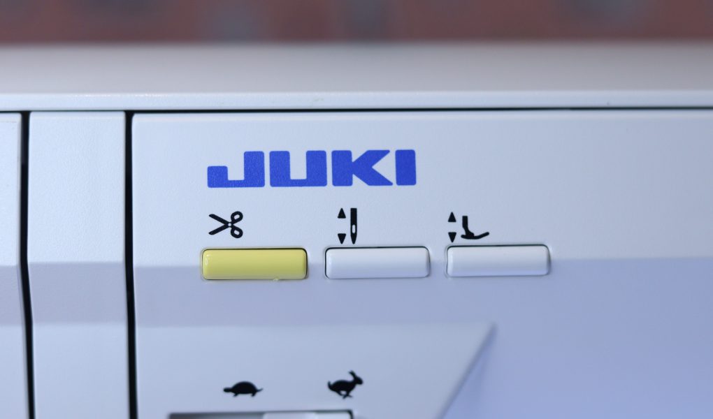 The thread trimmer button on the Juki NX7 sewing machine