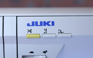 The thread trimmer button on the Juki NX7 sewing machine