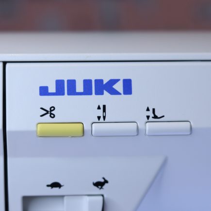 The thread trimmer button on the Juki NX7 sewing machine